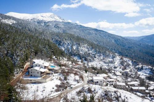 an aerial view of a village in the snow at Helmos Mountain Retreat in Zarouhla
