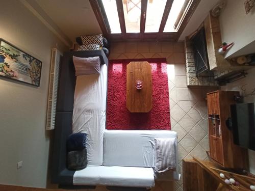 a living room with a white couch and a table at Helmos Mountain Retreat in Zarouhla