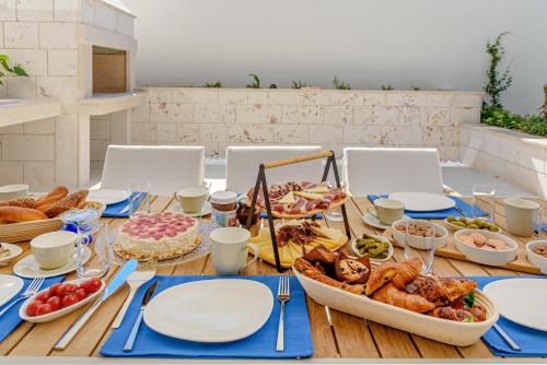 a table with plates and food on top of it at Villas Lucy - 1 Lemon -outdoor pool , 2 Cherry-indoor pool and 3 Plum-outdoor pool in Marina