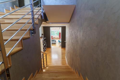 a hallway of a house with wooden floors and stairs at Luxury villa Bouskoura Pearl in Casablanca