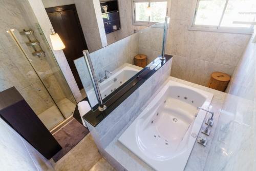 a large bathroom with a tub and a sink at Luxury villa Bouskoura Pearl in Casablanca