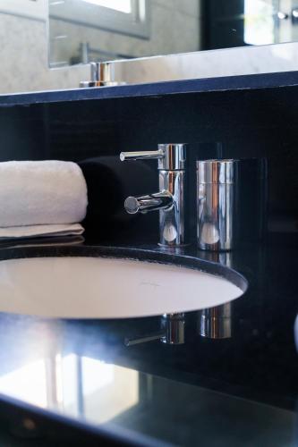 a close up of a sink in a bathroom at Luxury villa Bouskoura Pearl in Casablanca