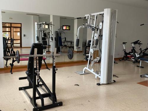 a gym with a bunch of equipment in a room at H Sweet H Airport Ifema Metropolitano in Madrid