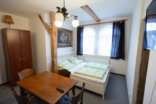 a small room with a bed and a table at Apartmány U Davídků in Cerny Dul