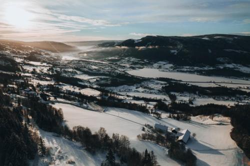 an aerial view of a snow covered valley with trees at Hafjell Farmhouse in Øyer