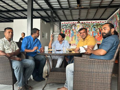 een groep mannen aan een tafel bij Mithila Thali By Chef Santosh Shah in Janakpur