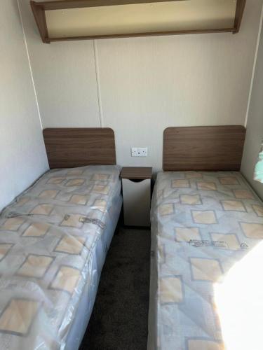 two beds sitting next to each other in a room at Perranporth Holiday Park in Perranporth