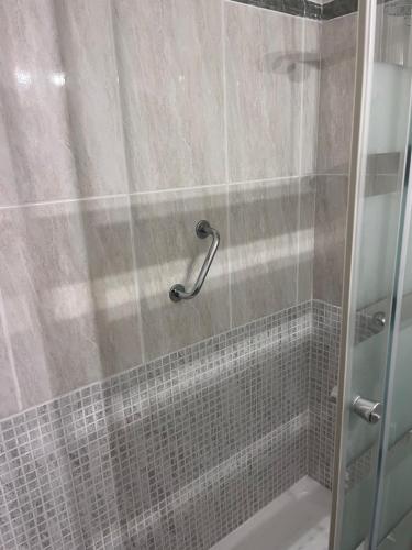 a shower with a glass door in a bathroom at Los Quebrantos in San Juan de la Arena