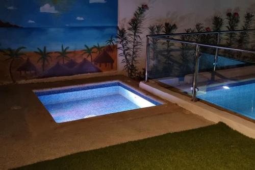 a swimming pool in the middle of a house at Villa Massai avec piscine au cœur de Saly in Sali Nianiaral