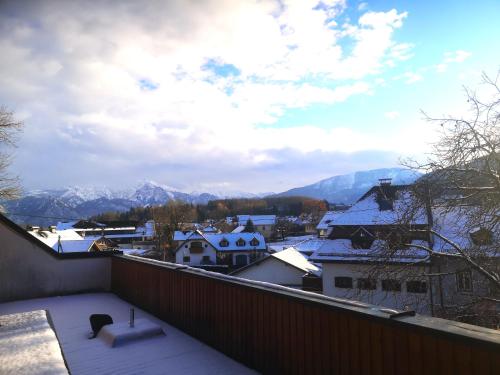 a balcony with a view of snow covered mountains at Hotel Wirt Z'Minsta in Altmünster