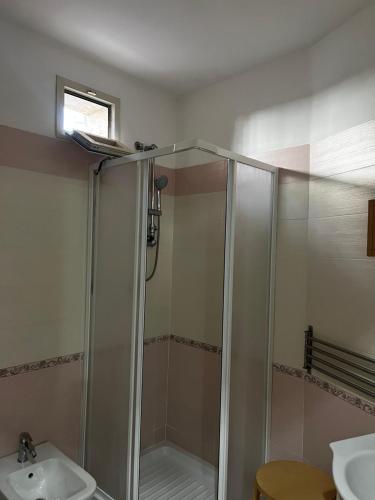 a bathroom with a shower and a sink at Family Room in Portici