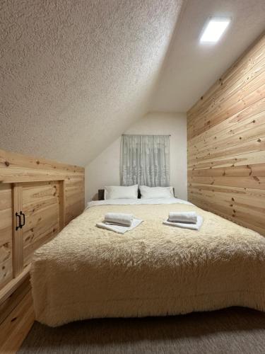 een slaapkamer met een bed met twee handdoeken erop bij Apartman Filip in Kolašin