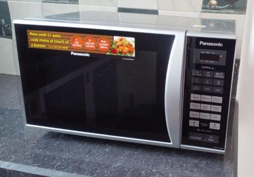 a microwave oven with a sign on the front of it at Lake View Villa in Mirissa