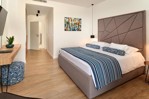 a bedroom with a large bed and a desk at Villas Lucy - 1 Lemon -outdoor pool , 2 Cherry-indoor pool and 3 Plum-outdoor pool in Marina