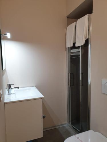 a bathroom with a shower and a sink and a toilet at Piccolo Hotel Olina in Orta San Giulio
