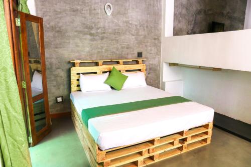 a bedroom with a wooden bed in a room at Cinnamon Eco Villa 1 in Hikkaduwa