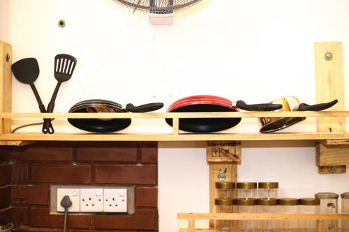 a wooden shelf with plates and utensils on it at Cinnamon Eco Villa 1 in Hikkaduwa