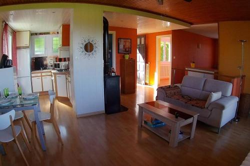 a living room with a couch and a table at L'ELGIA, gîte 3 épis, 3 étoiles in Saint-Martin-d'Uriage