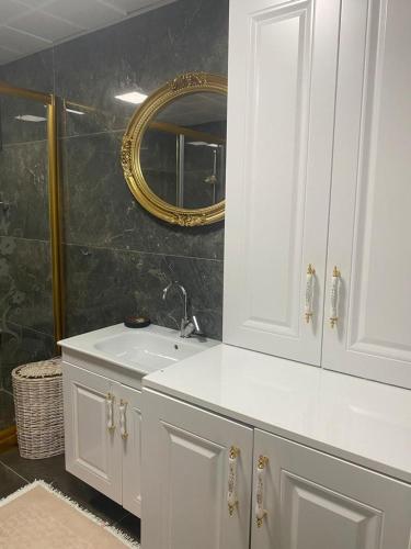 a bathroom with a white sink and a mirror at Konuk evi in Karaköprü Köyü