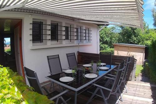 a black table and chairs on a patio at L'ELGIA, gîte 3 épis, 3 étoiles in Saint-Martin-d'Uriage