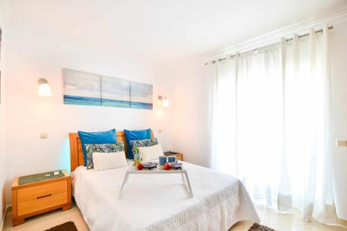 En eller flere senge i et værelse på Apartamento Moderno Albufeira L14