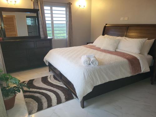 a bedroom with a bed with two towels on it at Mount Joy Getaway in Parham