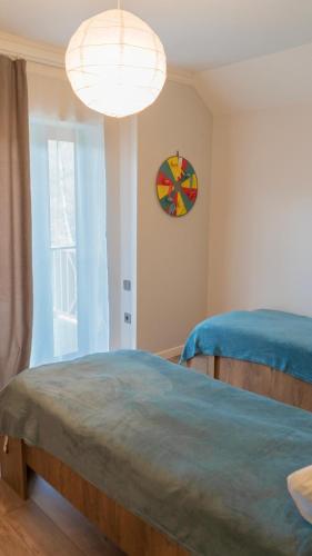 a bedroom with a bed and a clock on the wall at CHALET WOODS GUSAR in Qusar