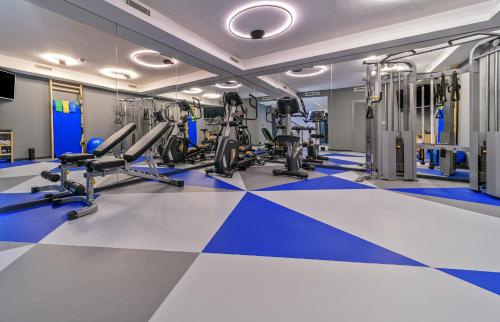 a gym with blue and white floors and treadmills at Villas Lucy - 1 Lemon -outdoor pool , 2 Cherry-indoor pool and 3 Plum-outdoor pool in Marina