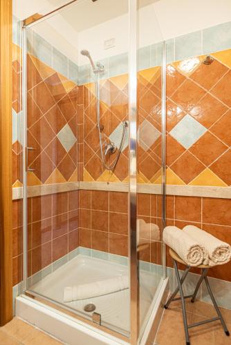 a shower with a glass enclosure in a bathroom at Ginestre38 in Pula