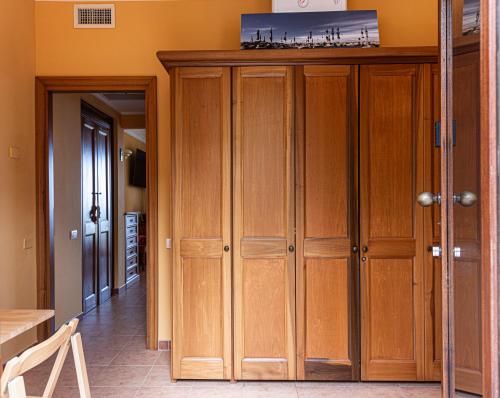 a room with wooden cabinets and a hallway at Ginestre38 in Pula