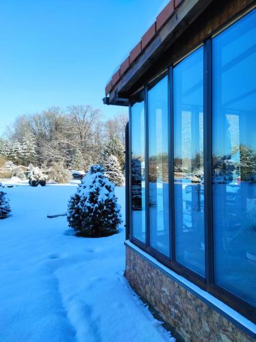 a window of a building in the snow at Penzion Kosky in Hamr