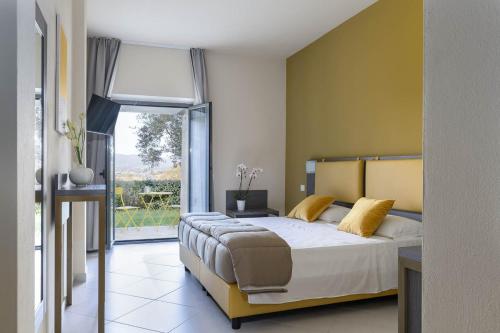 Postel nebo postele na pokoji v ubytování Tuscasì Aparthotel