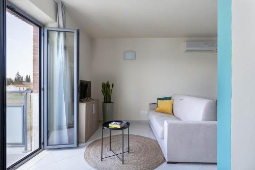 a living room with a couch and a table at Tuscasì Aparthotel in Sovicille