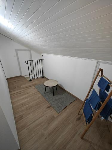 a attic room with a table and a chair at Appartement proche du centre in Thonon-les-Bains