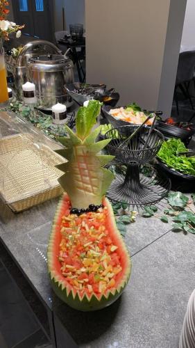 a plate of food on a table with a fruit salad at فندق جولدن نيو الصفا - Golden New Al Safa Hotel in Jeddah