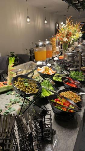a buffet with many bowls of food on a table at فندق جولدن نيو الصفا - Golden New Al Safa Hotel in Jeddah