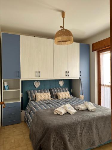 a bedroom with a bed with two towels on it at CASA SOFIA in Scalea