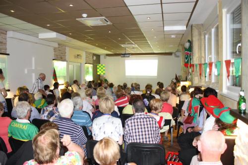 a crowd of people sitting in a room with a presentation at Irish House Međugorje in Međugorje
