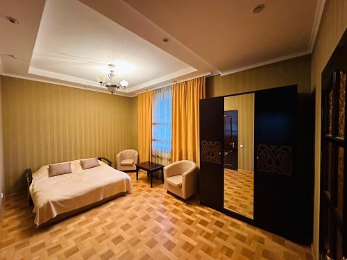 a bedroom with a bed and a table and chairs at VerhoVilla in Verkhovyna