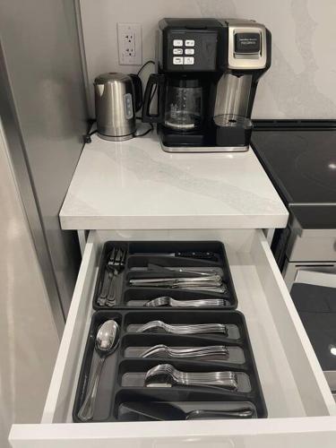 a kitchen with a coffee maker on top of a refrigerator at luxury & Spacious 2 bedrooms basement serviced apartment in Brampton