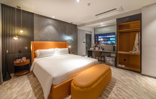 a hotel room with a large bed and a kitchen at New Century Dalat Hotel in Da Lat