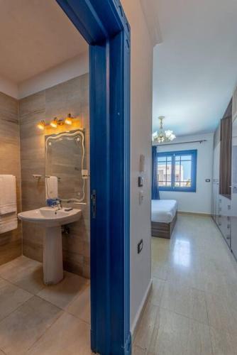 a bathroom with a sink and a bed in a room at Spacious villa with private pool in Hurghada
