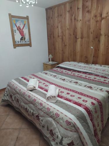 - une chambre avec 2 lits et des serviettes dans l'établissement Maison Vallet CIR VDA-VALTOURNENCHE n 0023, à Valtournenche