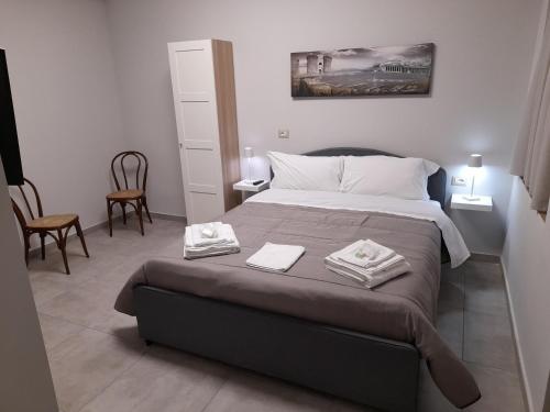 una camera da letto con un letto e due asciugamani di MOM'S HOUSE VOMERO a Napoli