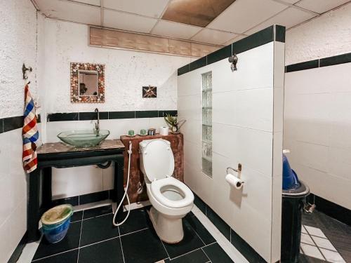 a bathroom with a toilet and a sink at Baan Suanthip Homestay - Aoluek Natural Retreat in Ao Luk
