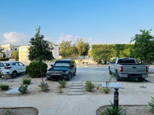 two cars parked in a parking lot at 1-Bedroom on Forest Island & Oceanside View in Salalah