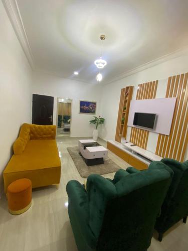 a living room with a couch and a tv at Excel suite by Home Glides in Lekki