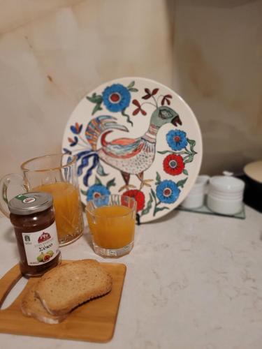 a plate with a rooster on it next to a plate with a piece at City Center Suites in Karpathos Town
