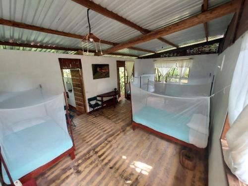 a room with two bunk beds in a house at Portal del Sol in Villagarzón