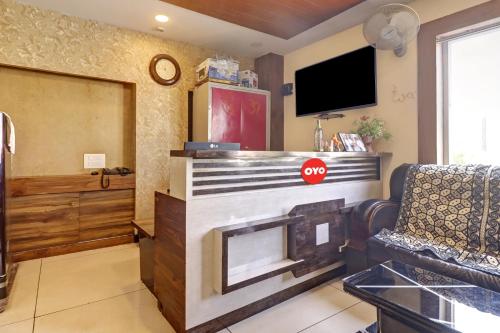 a living room with a fireplace and a tv at Bhagirathi Residency in Anantapur